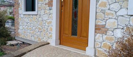 A stone building with a wooden door and a window.