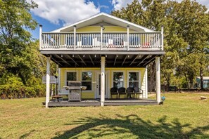 A two-story building with a balcony, a grill, and outdoor seating. - 2 Lakefront Luxury Homes, Private Dock & Firepit (Quinlan)