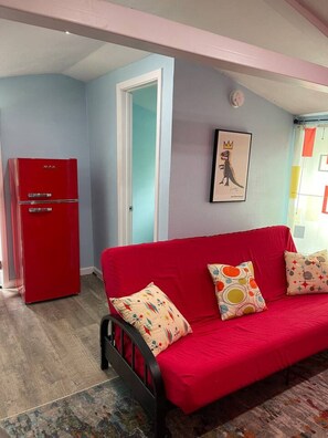 A room with a red sofa, a red refrigerator, and a wall with a framed picture. - 2 Lakefront Luxury Homes, Private Dock & Firepit (Quinlan)