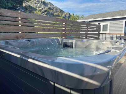 Escape to The Blue Bird – a cozy 2-bedroom cottage with hot tub and partial ocean views! Just 5 mins from Carbonear & 15 mins to Salmon Cove Sands.