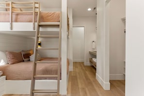 A bunk bed with a ladder, a bedside table, and a nightstand. - Paradise Palace: Lagoon Front! Pool + Waterslide (St. George)