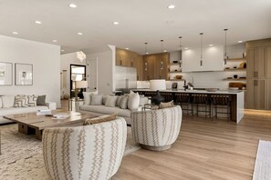 A modern living room with a sofa, armchairs, and a coffee table. - Paradise Palace: Lagoon Front! Pool + Waterslide (St. George)