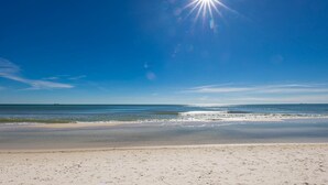 A beach with a clear sky and sunlight. - Phoenix Viii 81105 1 Bedroom Condo (Orange Beach)