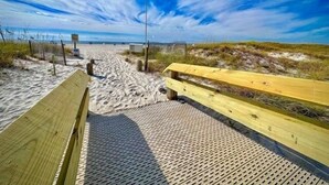 A wooden boardwalk leading to a beach with a clear sky. - Phoenix Viii 81206 3 Bedroom Condo (Orange Beach)