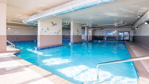 An indoor swimming pool with clear water, tiled walls, and a ceiling with visible ductwork. - Phoenix Vii 7201 3 Bedroom Condo (Orange Beach)