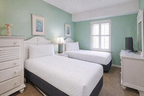 A bedroom with two beds, a dresser, a nightstand, a lamp, and a television. - Phoenix Viii 81106 3 Bedroom Condo (Orange Beach)
