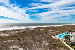 A beach resort with a swimming pool, beach access, and a boardwalk. - Phoenix Viii 8502 2 Bedroom Condo (Orange Beach)