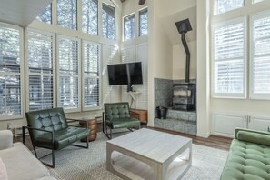 A spacious living room with large windows, a fireplace, and comfortable seating. - Stunning Sunlit & Spacious-1BR/2BTH+Loft (Mammoth Lakes)
