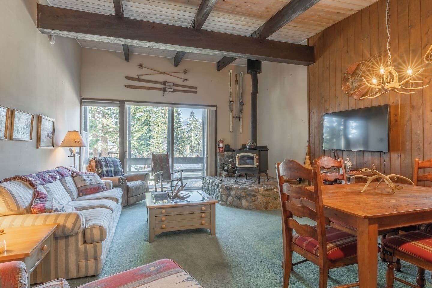 A cozy living room with a sofa, a coffee table, and a fireplace.