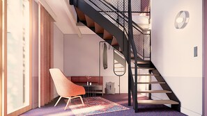 A modern interior with a staircase, a chair, and a rug. - THE MEADOW Gronau by Hackmann (Gronau (Westphalia))