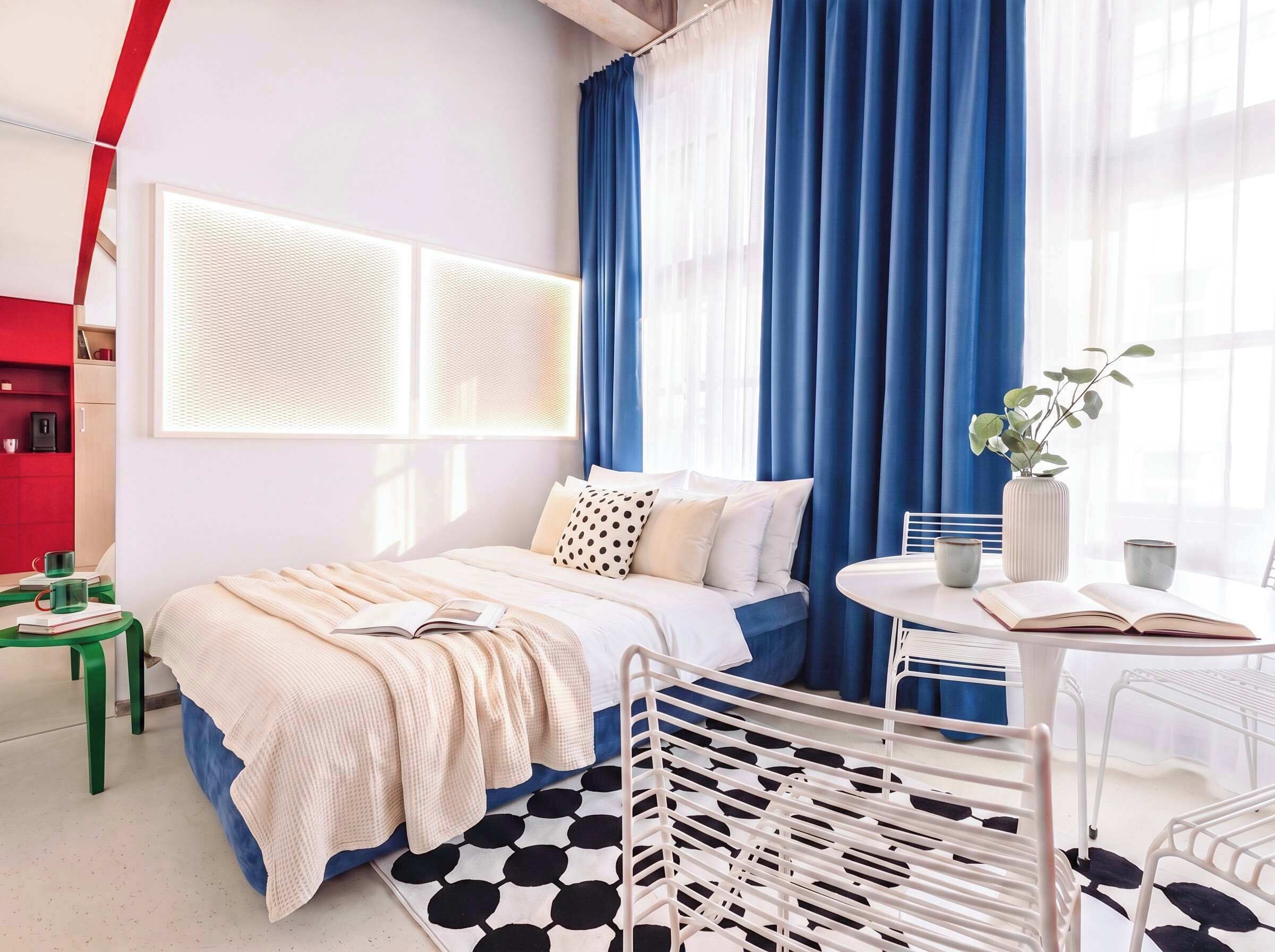 A modern bedroom with a bed, a desk, and a chair.