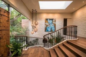 A modern staircase with a glass ceiling, wooden steps, and a metal railing. - Spacious spectacular 9-bedroom Fresnaye Villa (Cape Town)