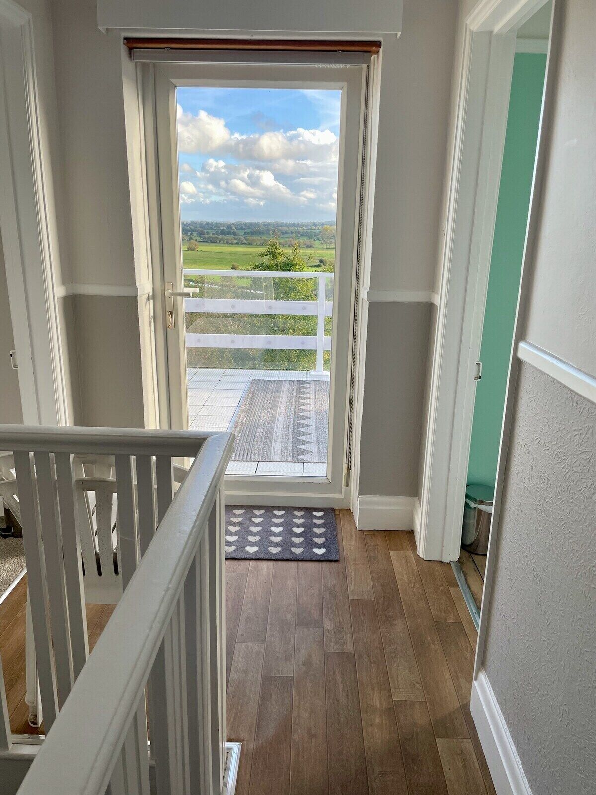 Upstairs hallway with entrance to the balcony