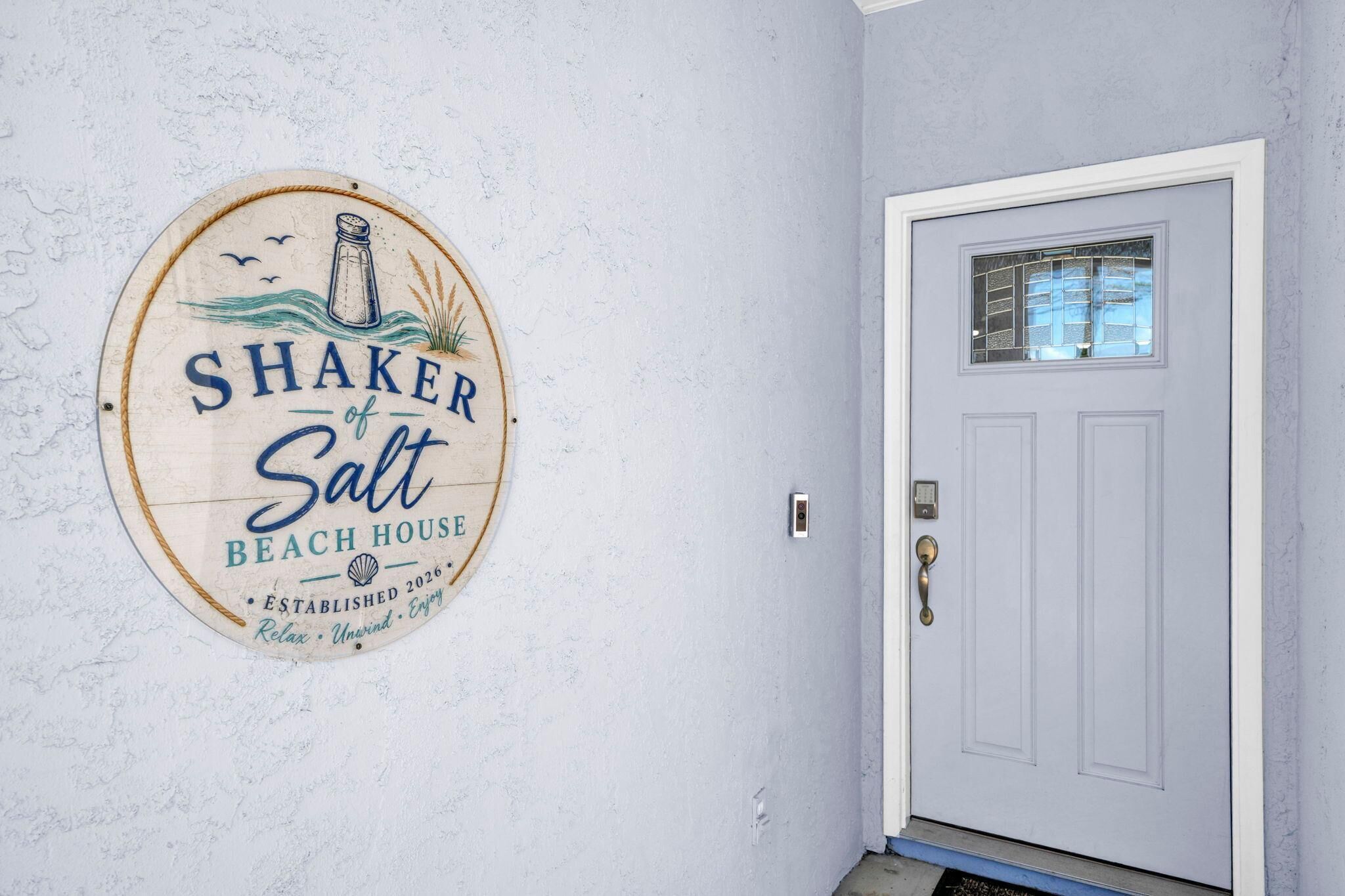 A door with a small window and a doorbell.