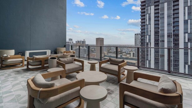 A balcony with seating and a city view. - Luxury 2BR | Downtown Miami Condo | Rooftop Pool (Miami)