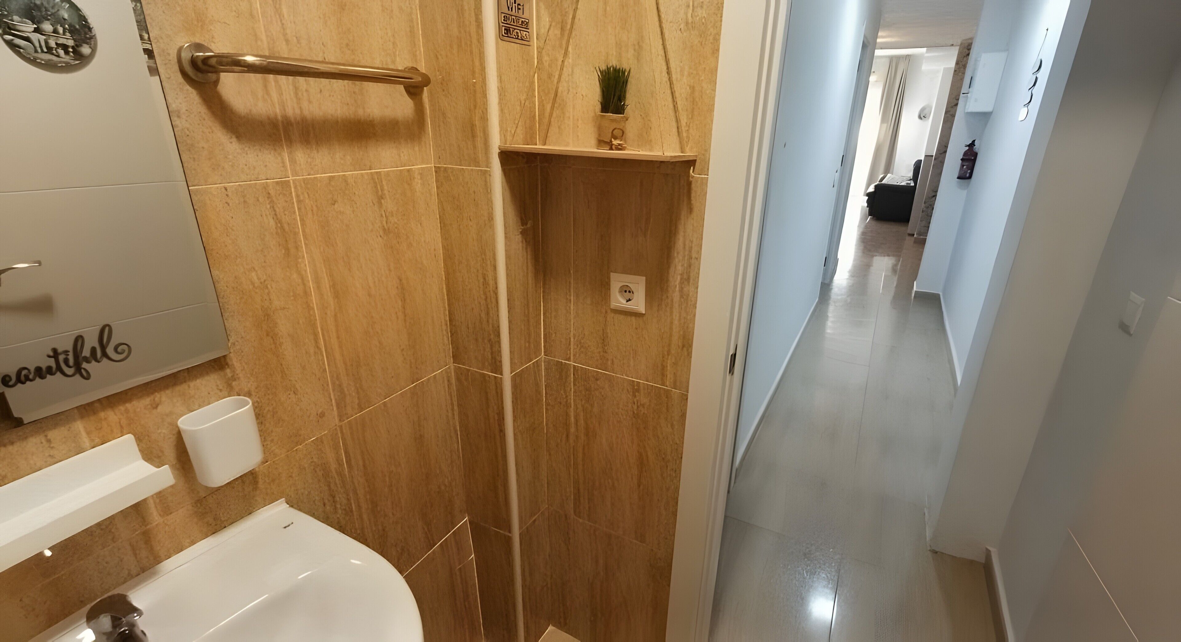 A bathroom with a bathtub, a towel rack, a shelf with a plant, and a sign on the wall.