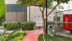 A pathway leading to a building with a modern design, including a vertical wooden panel and a concrete wall. - Refugio Natural en Santa Marta | Vista a la Sierra Nevada 2 hab, 2 baños, parking (Santa Marta)