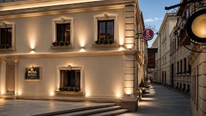 A hotel facade with illuminated signage, a grand entrance, and a street view. - Runa Hotel Baku (Baku)