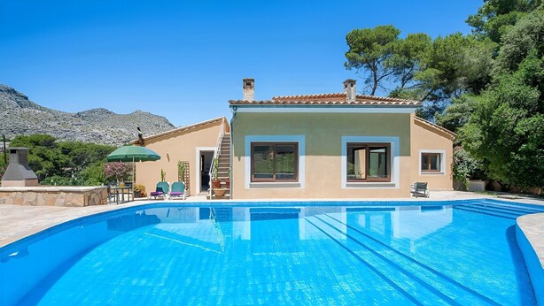 A swimming pool with a house in the background. - Villa "Alexandria" with Mountain View, Pool, A/C, Terrace & Garden (Cala Sant Vicenç)