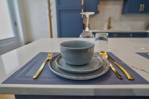 A dining table with a bowl, plate, and cutlery set. - Boutique Studio, Spa Bath & Parking, Sleeps 2 (Sherbrooke)