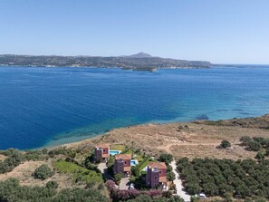 A coastal property with a clear view of the sea, a hilly landscape, and a distant mountain. - Villa Forteza - Three Bedroom Villa, Sleeps 6 (Kalami)