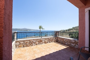 A balcony with stone walls and a view of the sea. - Villa Forteza - Three Bedroom Villa, Sleeps 6 (Kalami)