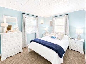 A bedroom with a bed, dresser, nightstands, and a window with curtains. - Lakeside Escape With Boat Slip (Rocky Mount)
