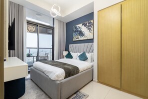 A modern hotel room with a bed, a TV, a large window, and a view of the outdoors. - Vogue Business Bay Aykon City near Metro Station (Business Bay)