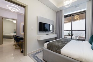 A modern hotel room with a bed, a TV, a desk, and a balcony with a view. - Vogue Business Bay Aykon City near Metro Station (Business Bay)