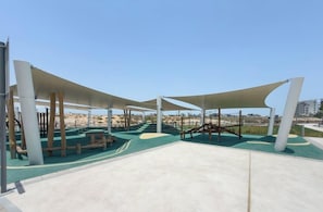 An outdoor playground with climbing structures and shaded areas. - Vogue, Albatross Yas Island near Ferrari World (Abu Dhabi)