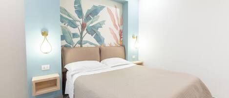 A bedroom with a bed, a wall-mounted shelf, and a wall art piece.
