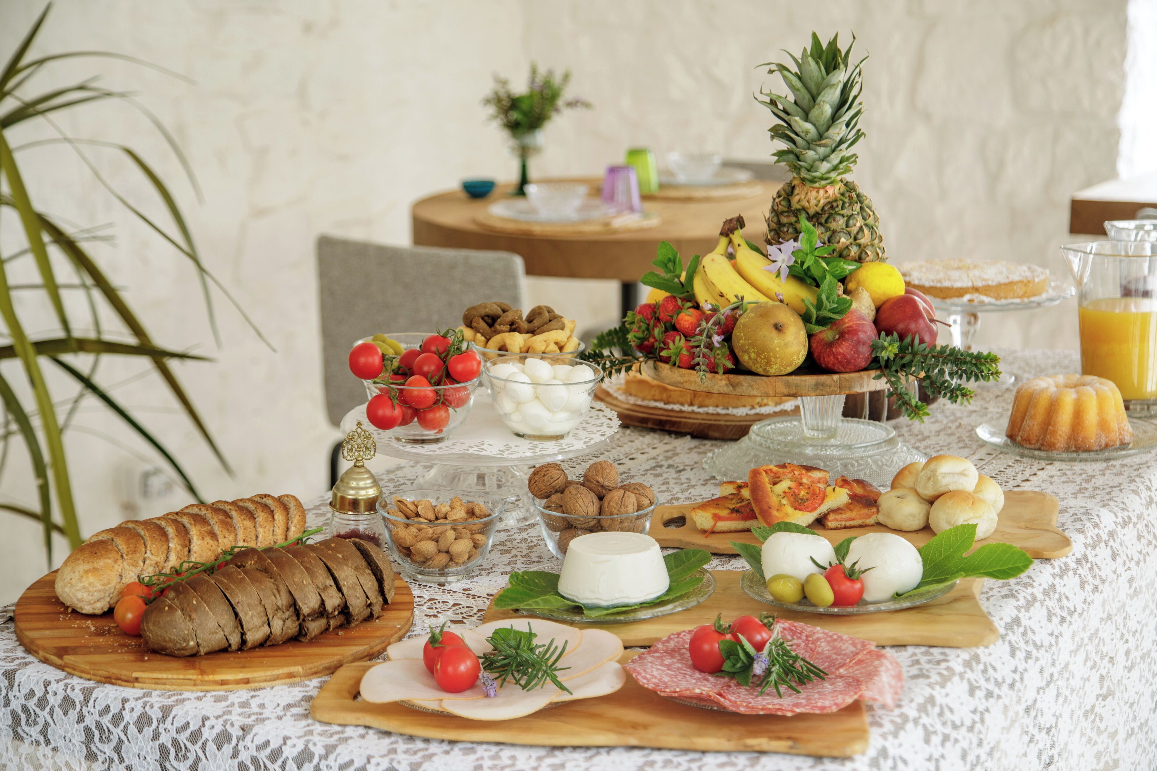 A breakfast buffet with various food items and a pineapple centerpiece.