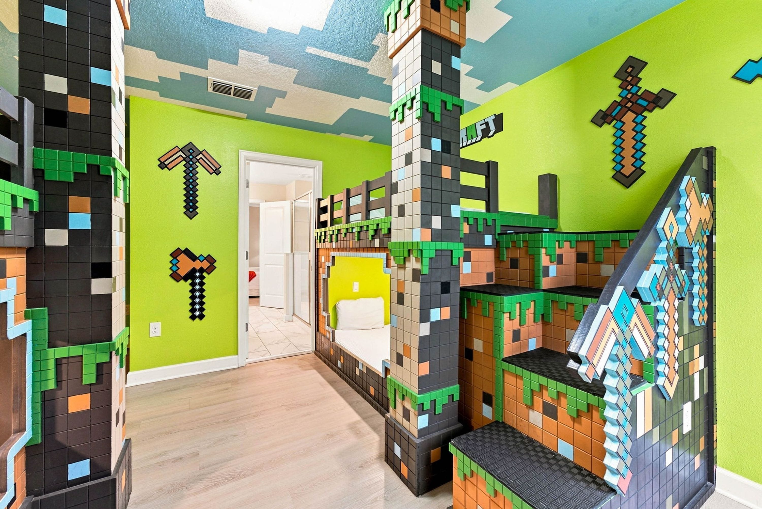 A room with a Minecraft-themed wall design, a bed, and a staircase.