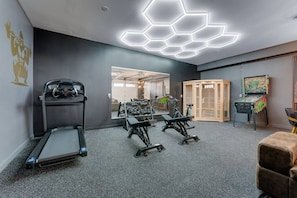 A gym with treadmills, weight machines, and a mirrored wall. - Luxury Ski in Lodge|Indoor pool|Sleeps 21|VIEWS! (McHenry)
