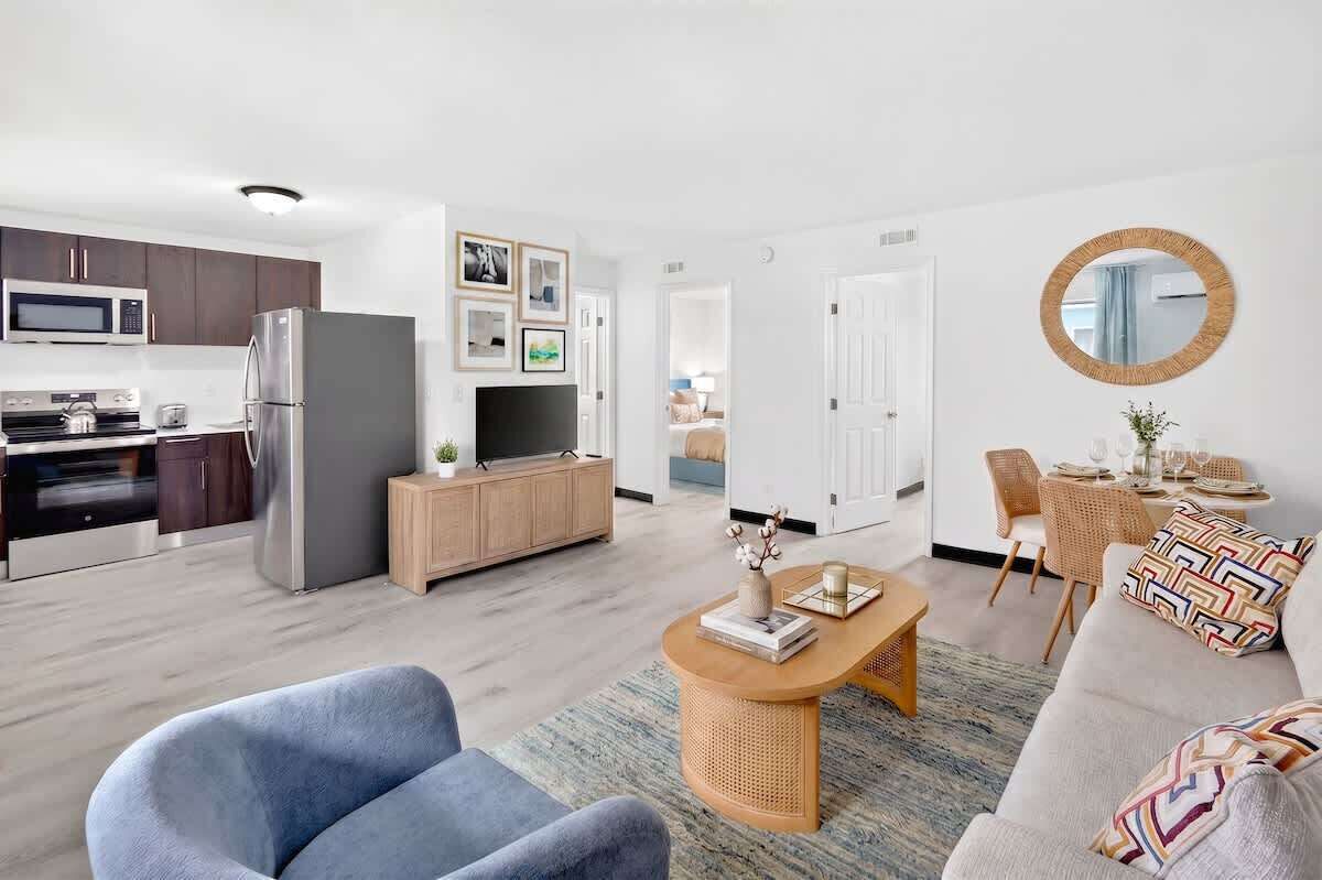 A modern apartment with a kitchen, living room, and dining area.