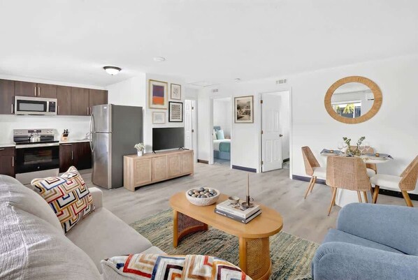 Een modern appartement met keuken, eethoek en woonkamer.