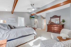 A bedroom with a bed, dresser, and a ceiling fan. - Lakefront! Sauna! HotTub! Sleeps 14! 1.5M to Wisp! (McHenry)