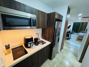 A modern kitchen with a microwave, coffee maker, sink, and refrigerator. - Ground-Floor Studio · Terrace & Rooftop Pool (Playa del Carmen)