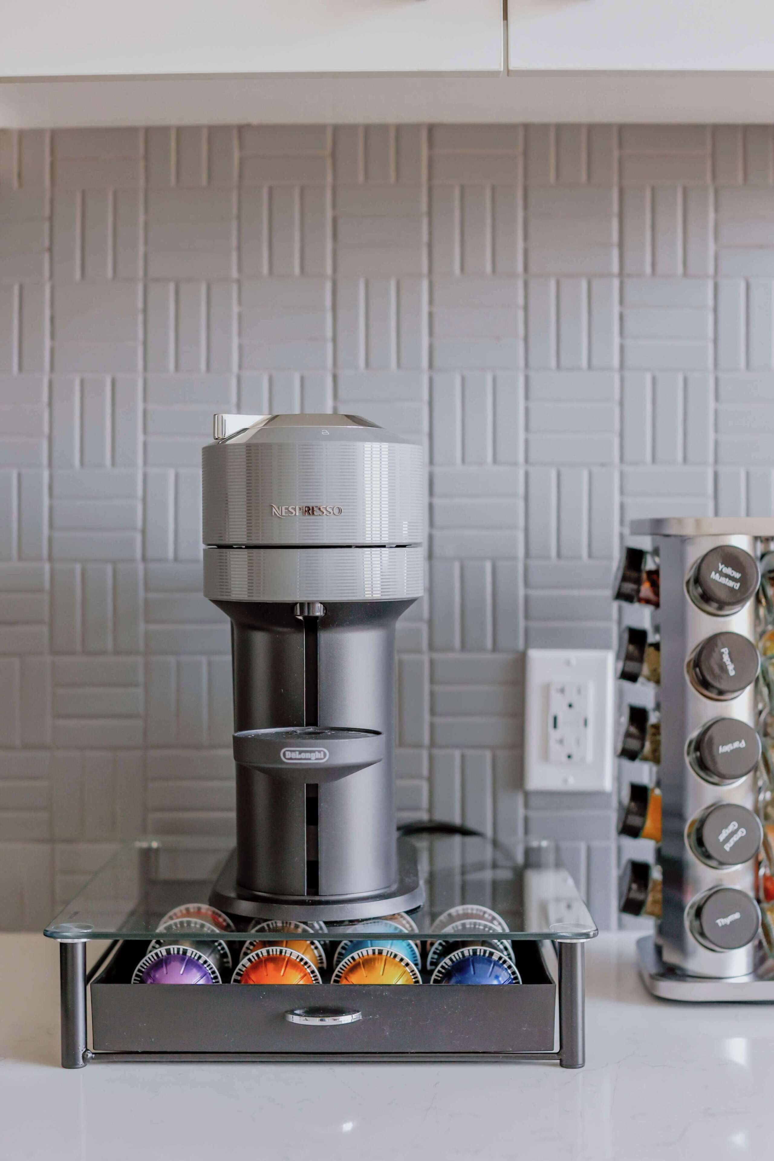 A coffee machine with a Nespresso pod holder below it.