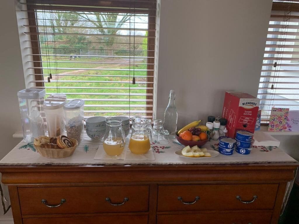 A kitchen counter with various food items and kitchenware.