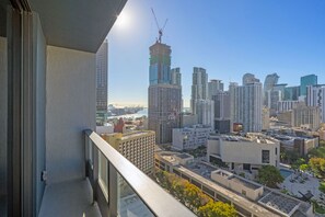 A high-rise building with a construction crane, surrounded by other tall buildings, and a view of a cityscape. - Botanical Boutique Studio in Miami Downtown (Miami)