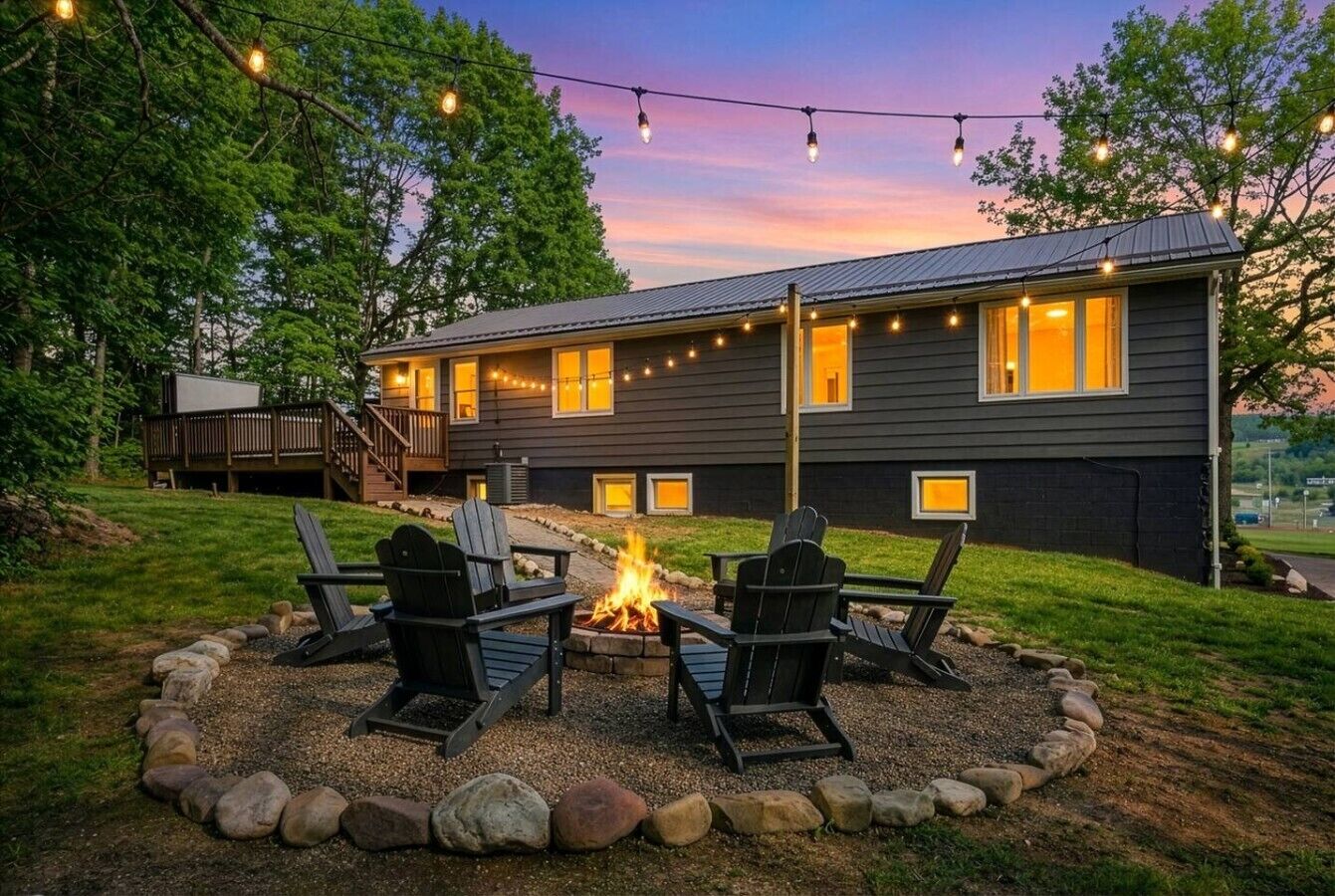 A house with a fire pit and outdoor seating.