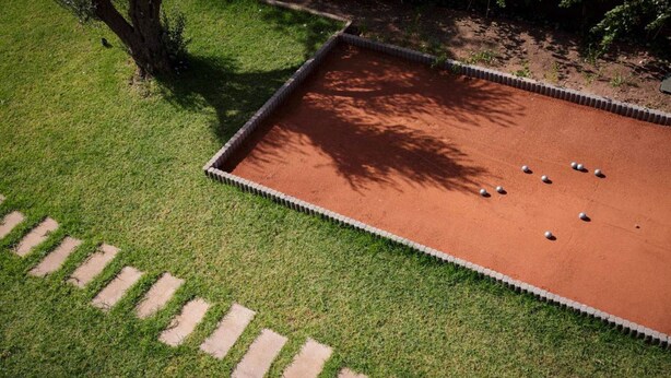 A rectangular outdoor area with a paved path leading to it, surrounded by grass. - Villa Dalaoui - Five Bedroom Villa, Sleeps 10 (Douar Moulay Abbas)
