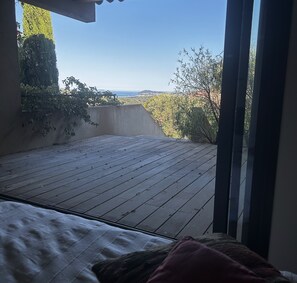 A room with a view of a wooden deck and a balcony. - Villa with pool and panoramic views in Ollioules (Ollioules)