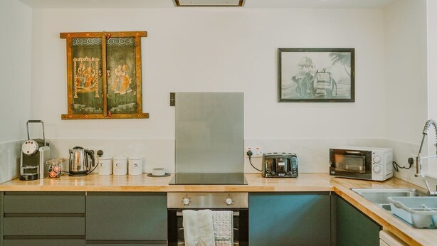 A modern kitchen with a refrigerator, microwave, toaster, and kettle. There are cabinets and a sink. - Skylarke - Five Bedroom Castle, Sleeps 10 (Portpatrick)
