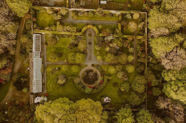 An aerial view of a park with a central circular feature, pathways, and a building with a long, narrow structure on the left. - Skylarke - Five Bedroom Castle, Sleeps 10 (Portpatrick)