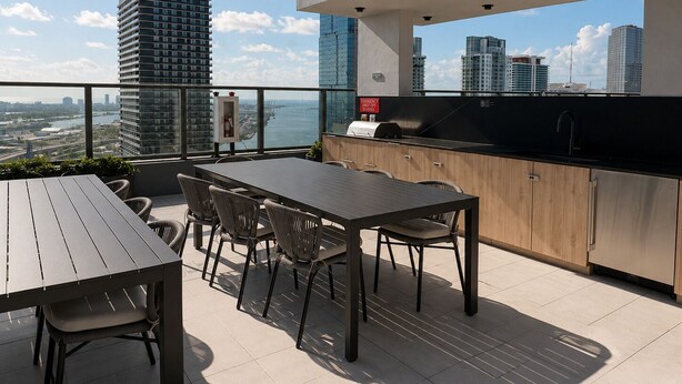 A rooftop terrace with a dining area, a bar, and a view of the city skyline. - Downtown Miami Boutique Residence with Rooftop Pool, Gym, Cowork & Den (Miami)