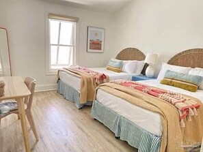 A room with two beds, a desk, and a window. - Bayou Breeze Unit 2 (Orange Beach)