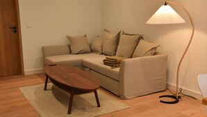 A living room with a sofa, a coffee table, and a floor lamp. - Exclusive "Backbord" vacation rental with private boat access and dock (Boren)