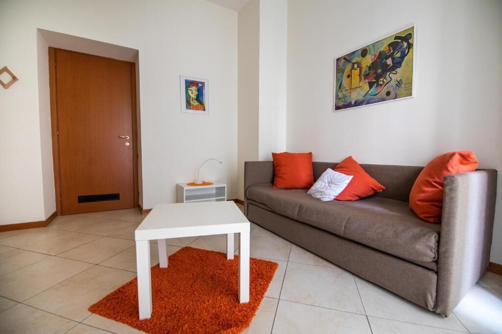 A living room with a sofa, a coffee table, and a rug.